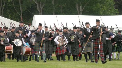 Massed Pipe Bands March Off Playing Wings And Scotland The Brave During