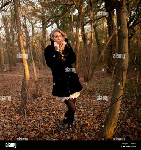 A Slim Blonde Woman Girl Alone In Woodland Autumn Afternoon Daytime Uk