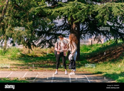Curly Haired Girl Comforting Her Brunette Friend While She Is Looking At Her Failed Exam Stock