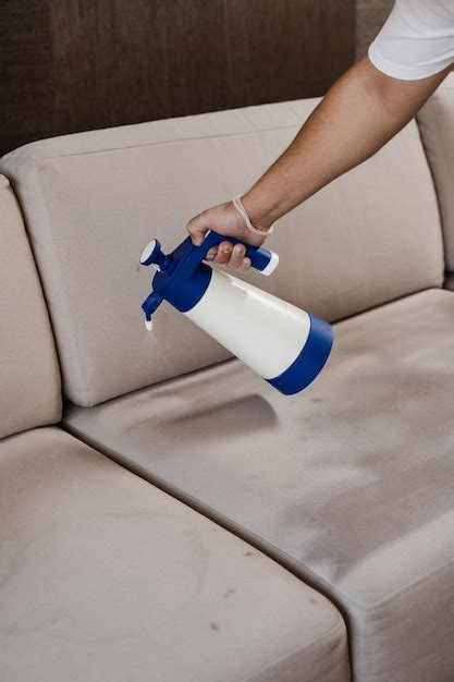 Premium Photo Spraying Detergent On Couch For Dry Cleaning Using