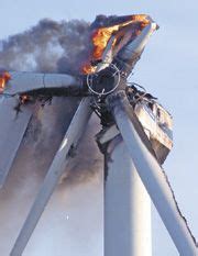 engineers hug   died atop  fiery wind turbine