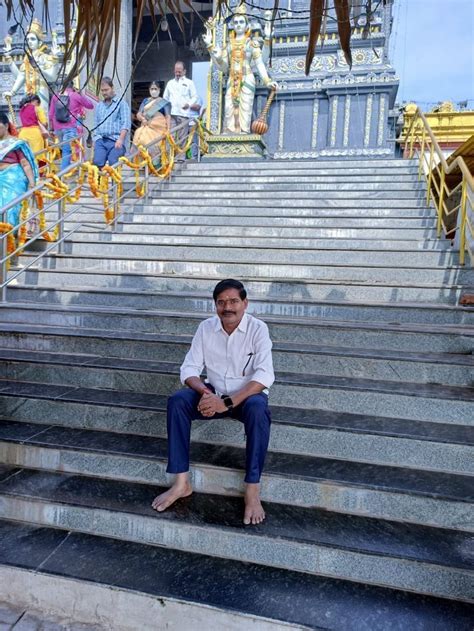 a man sitting on some steps in front of stairs