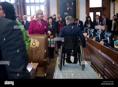 Texas Gov Greg Abbott Rolls His Wheelchair Down Ramp From Dais In The