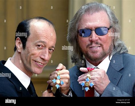 The Two Surviving Members Of The Bee Gees Robin Left And Barry Gibb Hold Their Cbe S After