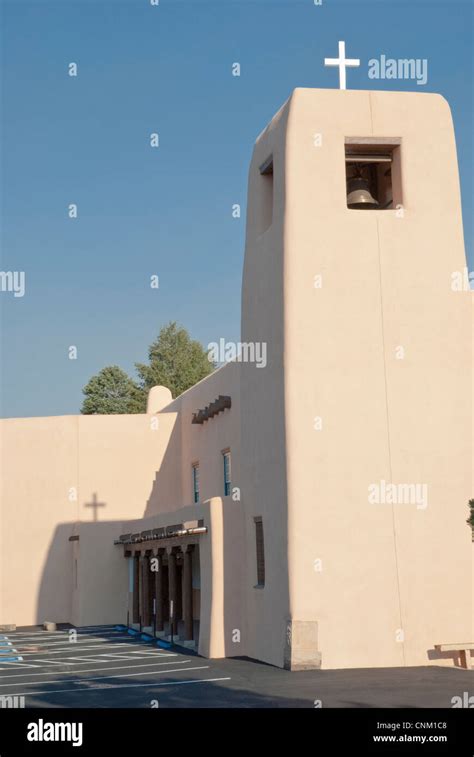 The cross atop the bell tower on the Cristo Rey Catholic Church casts ...