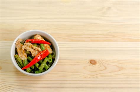 Premium Photo Spicy Stir Fried Pork With Red Curry Paste And Yard