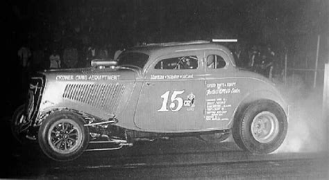 An Old Time Car With The Number Sixteen On It S Side In Front Of A Crowd