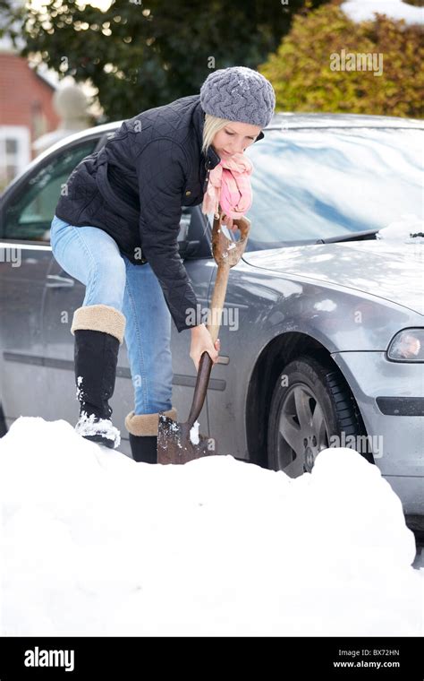 Woman Digging Out Car From Snow Stock Photo Alamy