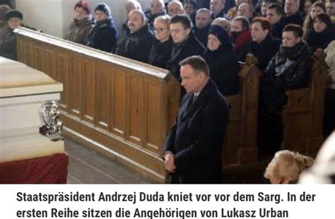 Polish President Andrzej Duda kneeling before the casket of Lukasz ...