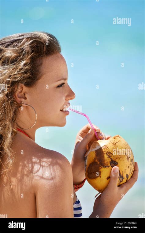 Woman Drinking Pinacolada Cocktail In Coconut On The Beach Of Varadero