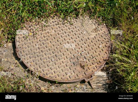 Large Round Cast Iron Manhole Cover In English Residential Garden Stock