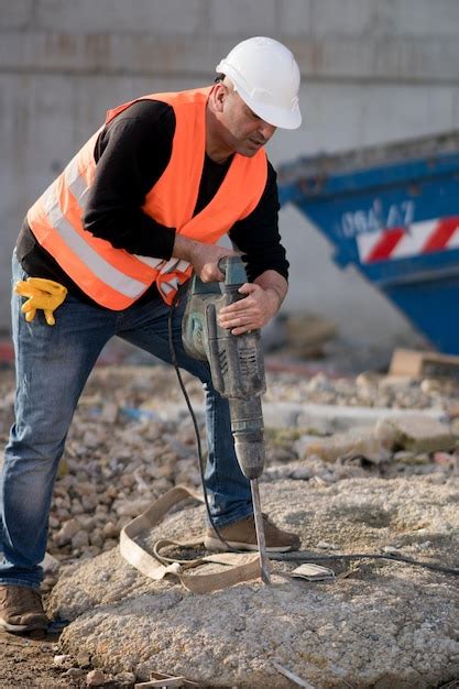 Premium Photo Worker Drilling With Jackhammer At Construction Site