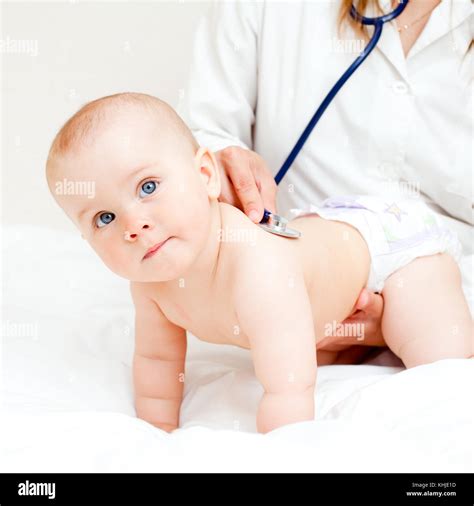 Pediatrician Examines Baby Girl Doctor Using A Stethoscope To Listen