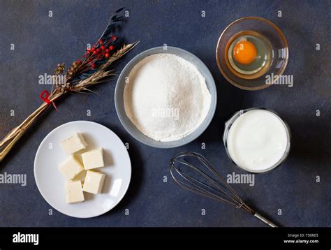 Ingredients For Crepes And Pancakes On A Dark Background Flour Egg Milk Butter Whisk Top