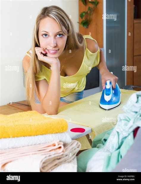 Smiling Blonde Girl Ironing With Iron At Home Stock Photo Alamy
