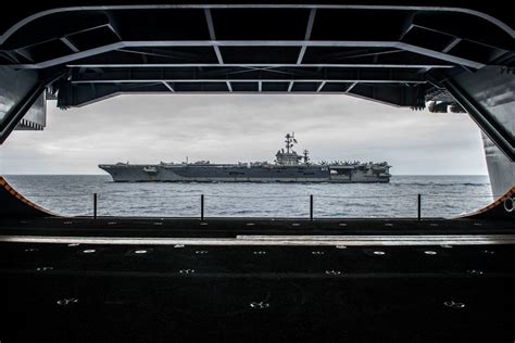 Uss George Washington Cvn 73 Is Framed By The Hangar Bay Of Another Aircraft Carrier Uss