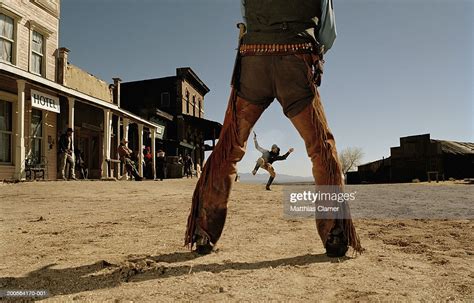 Cowboys Having Gun Duel In Old West Town Stock Photo Getty Images