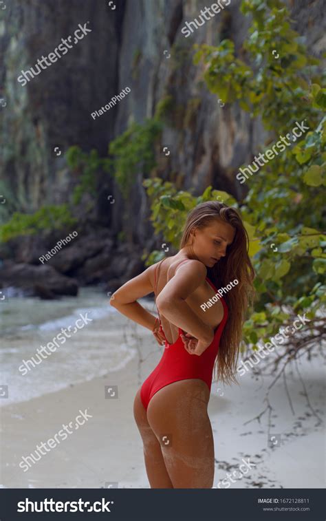 Sexy Tanned Brunette Red Swimsuit Posing Stock Photo