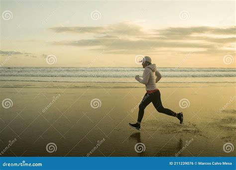 Fit And Attractive Mature Woman With Grey Hair Doing Beach Workout On Her S Running On The