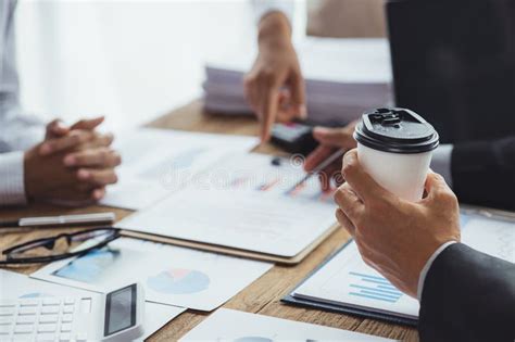 Close Up Of Person Holding A Paper Coffee Cup Business Meeting