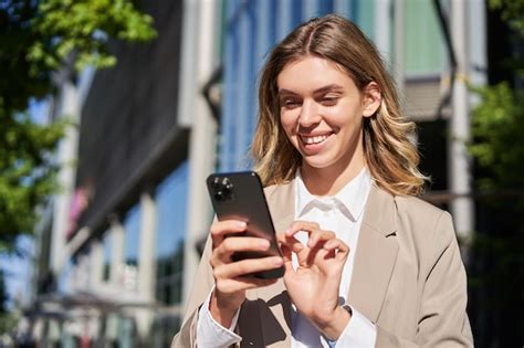 Free Photo Portrait Of Smiling Beautiful Businesswoman Using Her