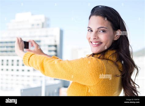 Pretty Brunette Taking Photos With Her Smartphone Stock Photo Alamy
