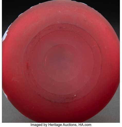 A Red Frisbee Sitting On Top Of A White Table Next To A Black Background