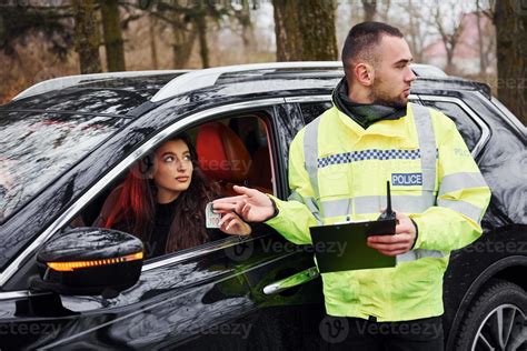 Male Police Officer In Green Uniform Takes Bribe From Woman In Car