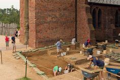 Archaeologists actively dig the site of the 1607 James Fort while a crowd looks on Jamestown ...