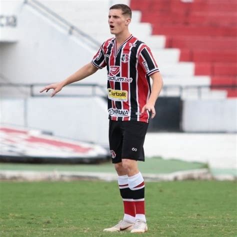 A Man Standing On Top Of A Soccer Field