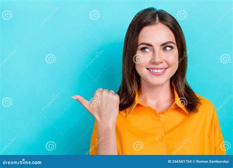 Photo Of Dreamy Cute Lady Wear Orange Shirt Showing Thumb Looking Empty Space Isolated Turquoise