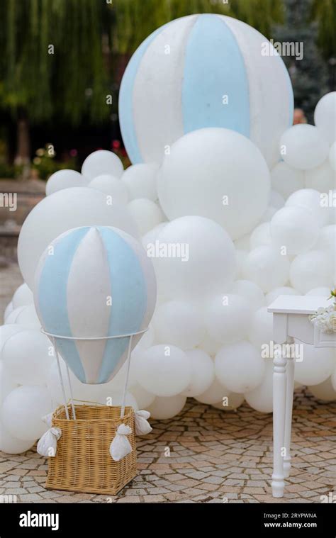 A Collection Of White Balloons And Blue Hot Air Balloons For A Baby Gender Reveal Party Stock