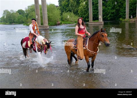 Performers and horses from Giffords Circus cool off in the River Wye at Hay on Wye Powys Wales ...