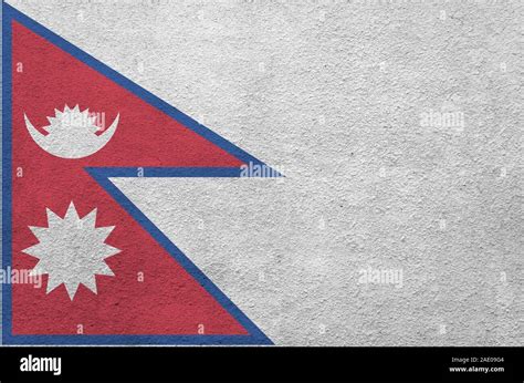 Nepal Flag Depicted In Bright Paint Colors On Old Relief Plastering