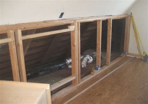 An Unfinished Room With Wood Framing And Insulation