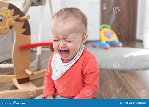 Girl Sitting On The Floor At Home And Crying One Year Old Baby Crying