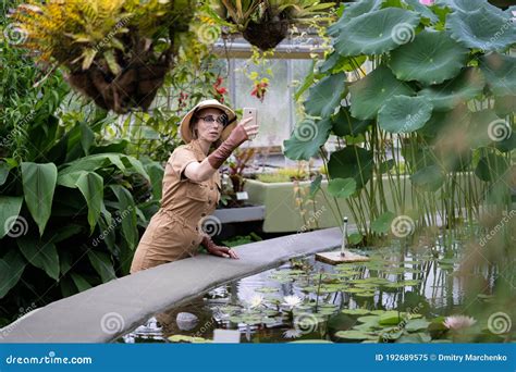 Woman Botanist Dressed In Safari Style In Greenhouse Naturalist Takes