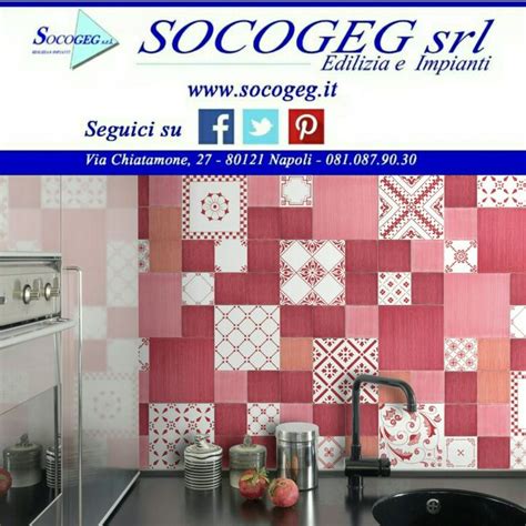 A Kitchen With Red And White Tiles On The Wall