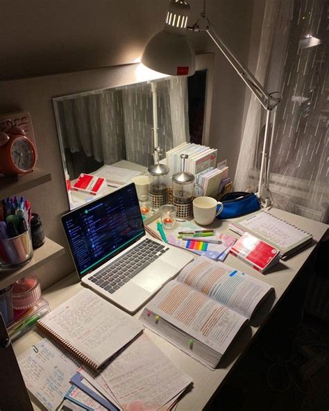 An Open Laptop Computer Sitting On Top Of A Desk Next To Books And