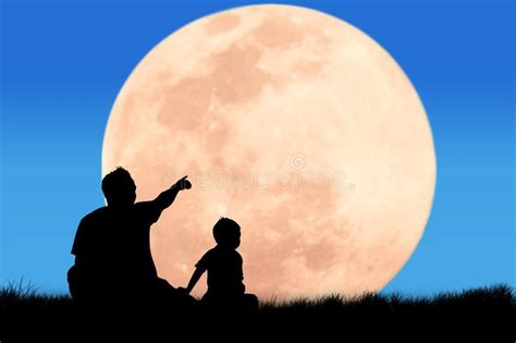 Silhouette Of Father Use Hand Point His Son Look At Full Moon Stock