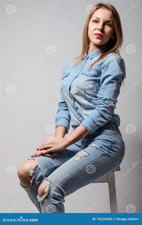 Happy Blonde Woman Smiling Sitting In Jeans Stock Photo Image Of