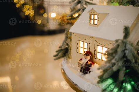 Festive installation in hotel. Houses with small Christmas tree and ...