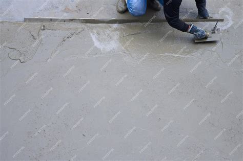 Premium Photo Workers Plastering Ready Mixed Concrete Floor At The