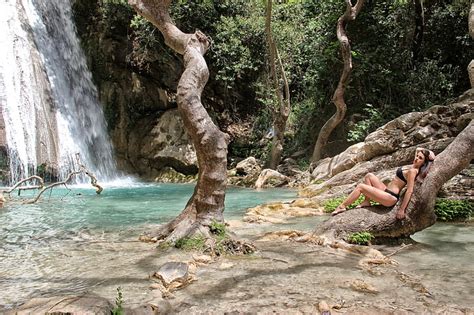 Royalty Free Photo Woman Wearing Black Bikini Lying On Brown Tree Trunk Beside Waterfalls