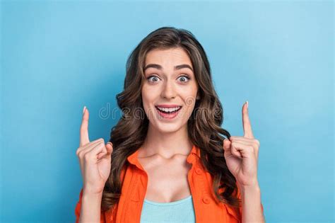 Photo Of Pretty Impressed Lady Wear Orange Jacket Pointing Two Fingers