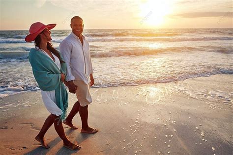 Rare True Love Young Couple Strolls At Sunset Beach Photo Background