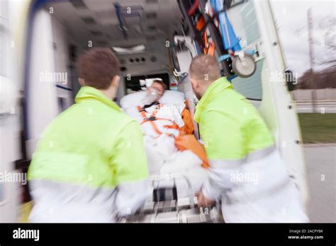 Cardiac Patient In An Ambulance Paramedics Loading A 50 Year Old