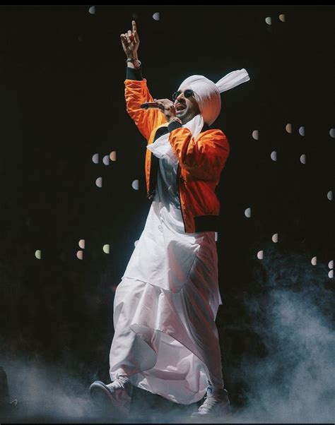 Diljit Dosanjh Performing in Orange and White Outfit