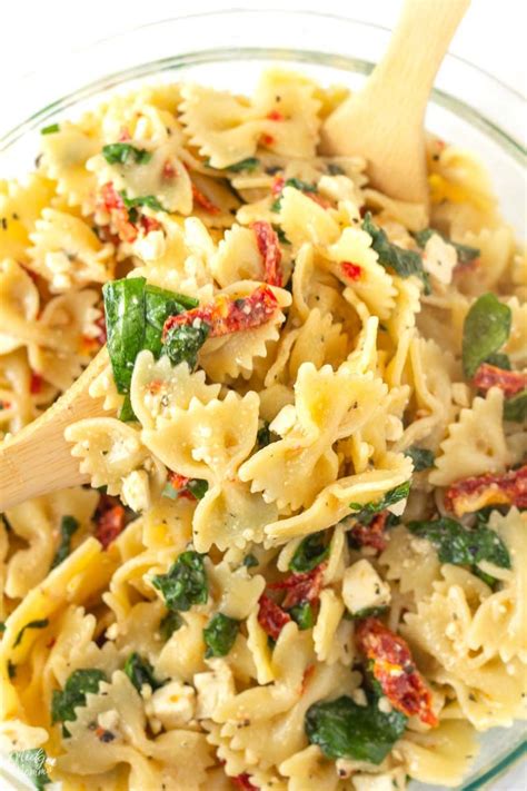 A Bowtie Pasta Salad With Spinach Feta Cheese And Sun Dried Tomatoes