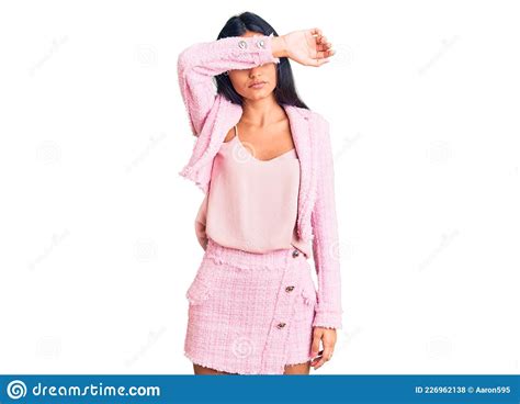 Young Beautiful Latin Girl Wearing Business Clothes Covering Eyes With